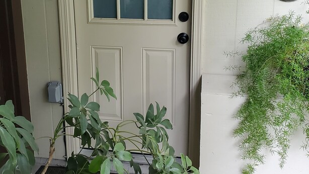 A white door with a frosted glass panel, a doorbell, and a welcome sign on the wall. - "the Sweet", close to downtown, beaches, parks, colleges, airports & hospitals. (Jacksonville)