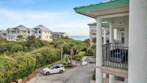 A coastal residential area with modern houses, a white car parked on the street, and a balcony with a railing. - ⭐200yds2Beach~Beach Access~4 Bikes~2Pools~The Coastal Gem (Santa Rosa Beach)