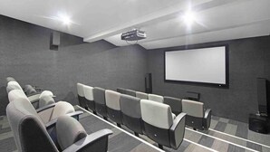 A conference room with rows of chairs, a projector, and a blank screen. - Central Rosebank Unit (Johannesburg)