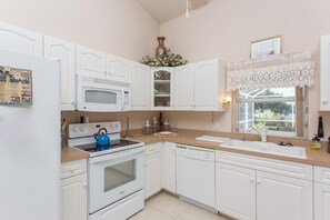 Enjoy cooking and cleaning in this fully equipped kitchen with appliances and ample countertop space.