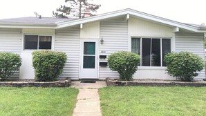 A single-story house with a front porch, a mailbox, and a number 4812 on the door.
