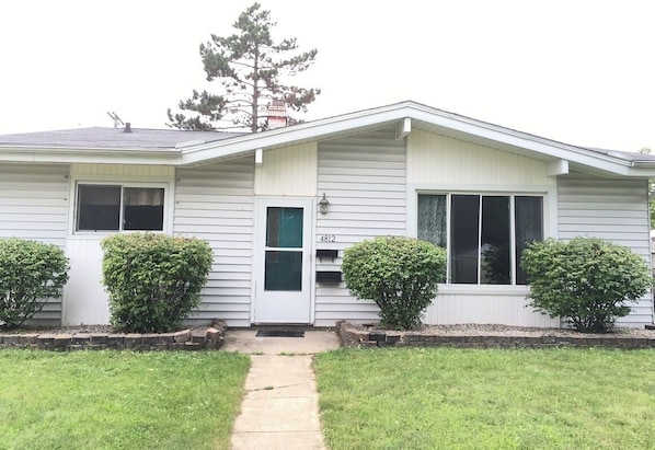 A single-story house with a front porch, a mailbox, and a number 4812 on the door.