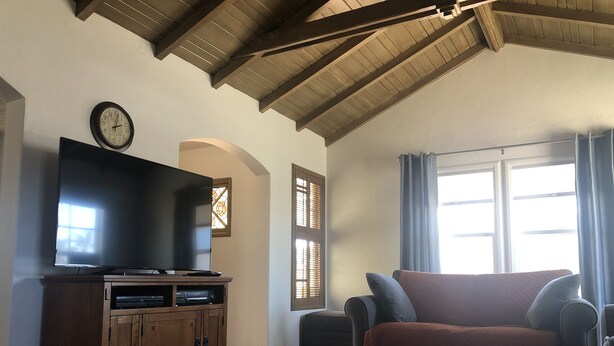 A living room with a television, wooden cabinet, and a couch. - The “Clubhouse” in the Village of Arroyo Grande (Arroyo Grande)