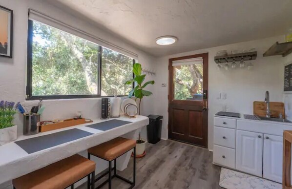 A compact kitchen with a window, a sink, and a countertop.