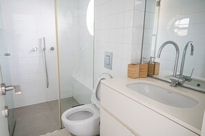 Shower, hair dryer, towels, toilet paper