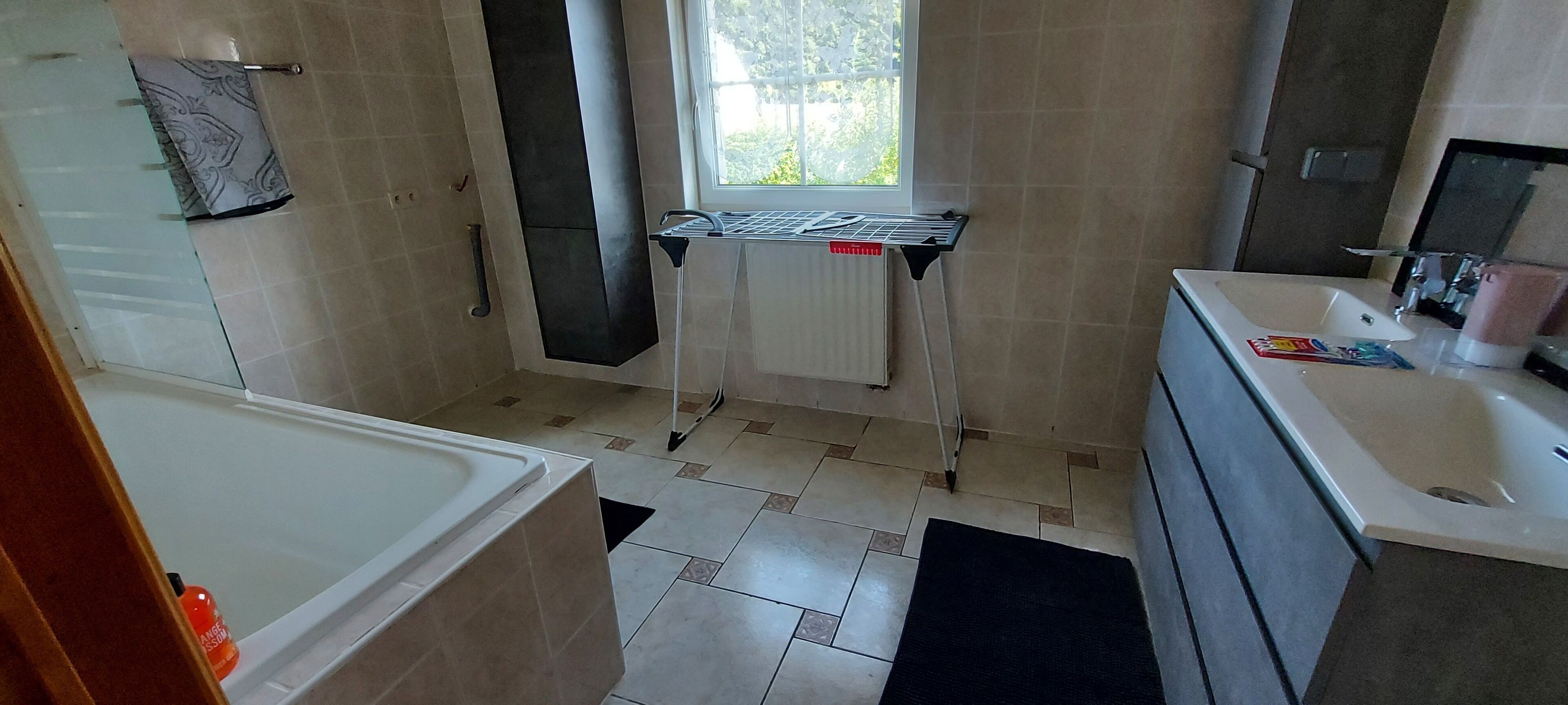 Bathtub, towels, soap, toilet paper