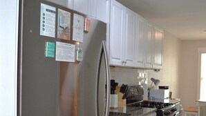 A modern kitchen with white cabinets, stainless steel appliances, and a granite countertop. - Central 1BDR+PetsOK+Extended Stay Discounts (Corpus Christi)