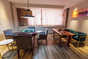A room with a pool table, chairs, a dining table, and a sofa. - Canal Hotel (Jiaxing)