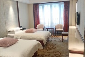 A hotel room with two beds, a small table, two chairs, a TV, and a view of the outdoors through large windows. - Taihua Hotel (Rugao)