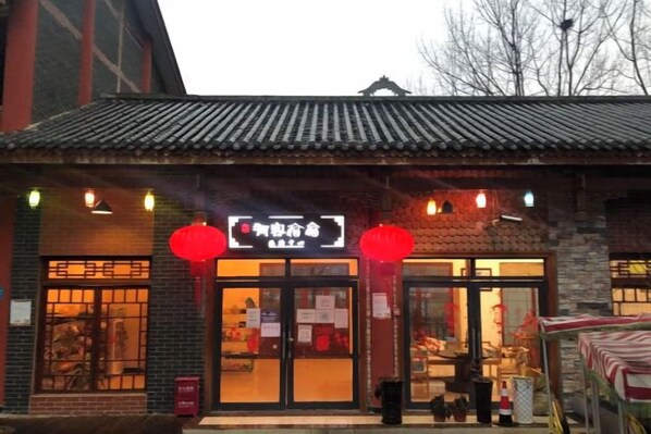 A traditional building with a tiled roof, a signboard, and red lanterns. - Youke Susu Hotel (Guiding Yinzhai) (Guiding)