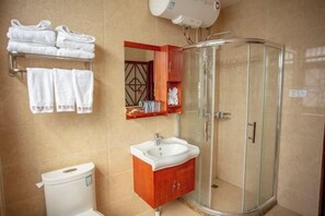 A bathroom with a toilet, sink, glass shower enclosure, and towel rack. - Youke Susu Hotel (Guiding Yinzhai) (Guiding)