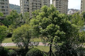 A residential area with multiple high-rise buildings, a well-maintained lawn, and a clear sky. - Youxiang Hotel (Wenzhou)