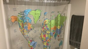 A shower curtain with a world map design.