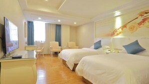 A hotel room with two beds, a desk with a TV, a chair, and a window with curtains. - Hongxing Boutique Hotel (Shantou)