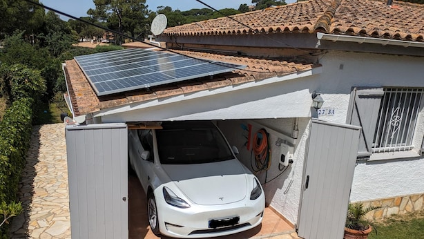 A white car parked in a garage with a solar panel on the roof. - Las flores 3A, Begur, Costa Brava (Begur)