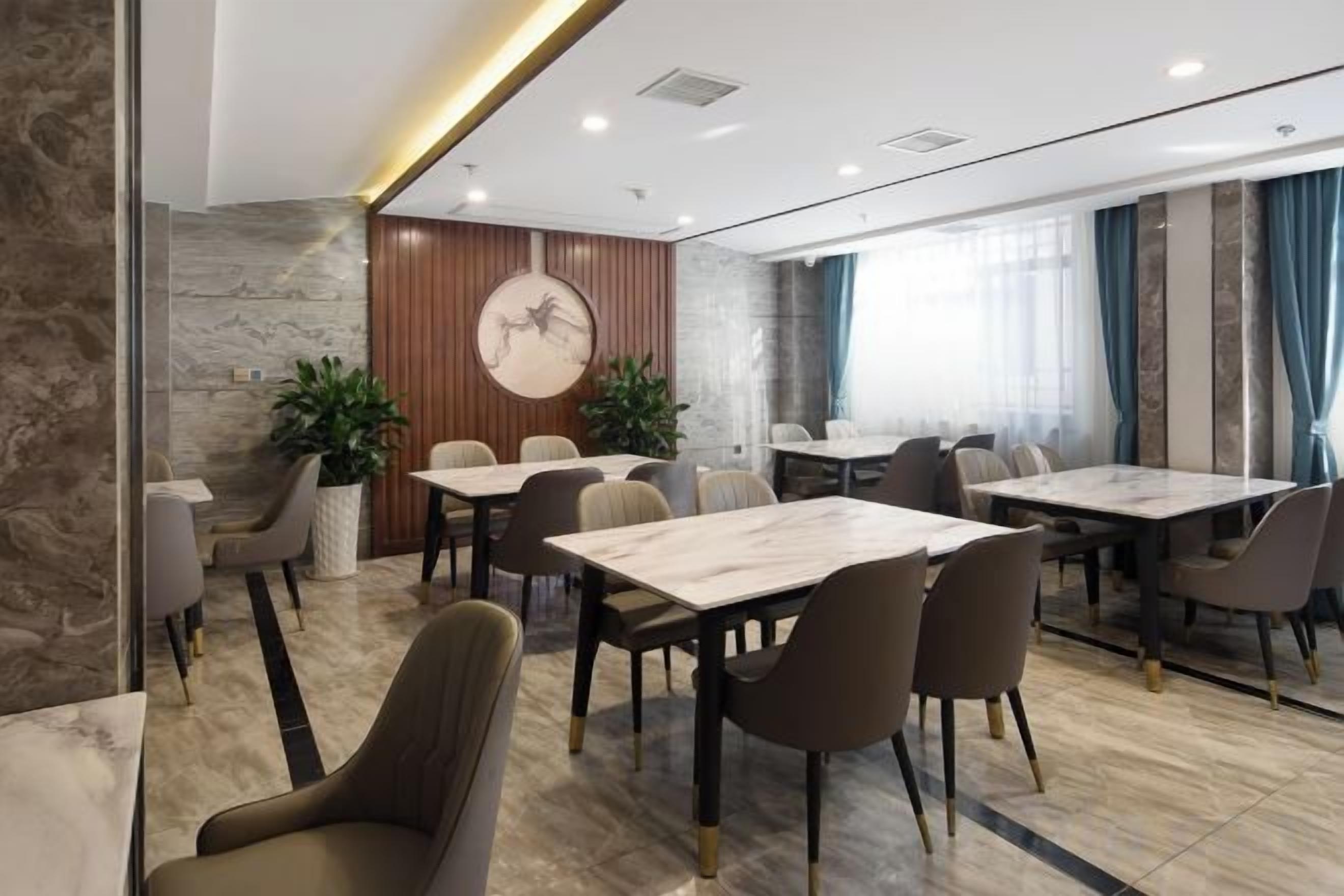 A modern conference room with marble flooring, wooden accents, and a large round table.