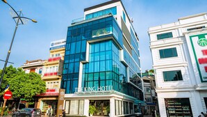 A modern hotel with a prominent glass facade and a sign reading "THE KING HOTEL". - The King Hotel condotel Thai Nguyen (Phan Dinh Phung)