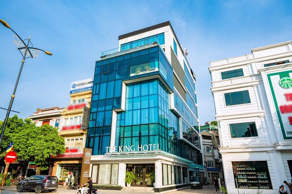 A modern hotel with a prominent glass facade and a sign reading "THE KING HOTEL". - The King Hotel condotel Thai Nguyen (Thai Nguyen)