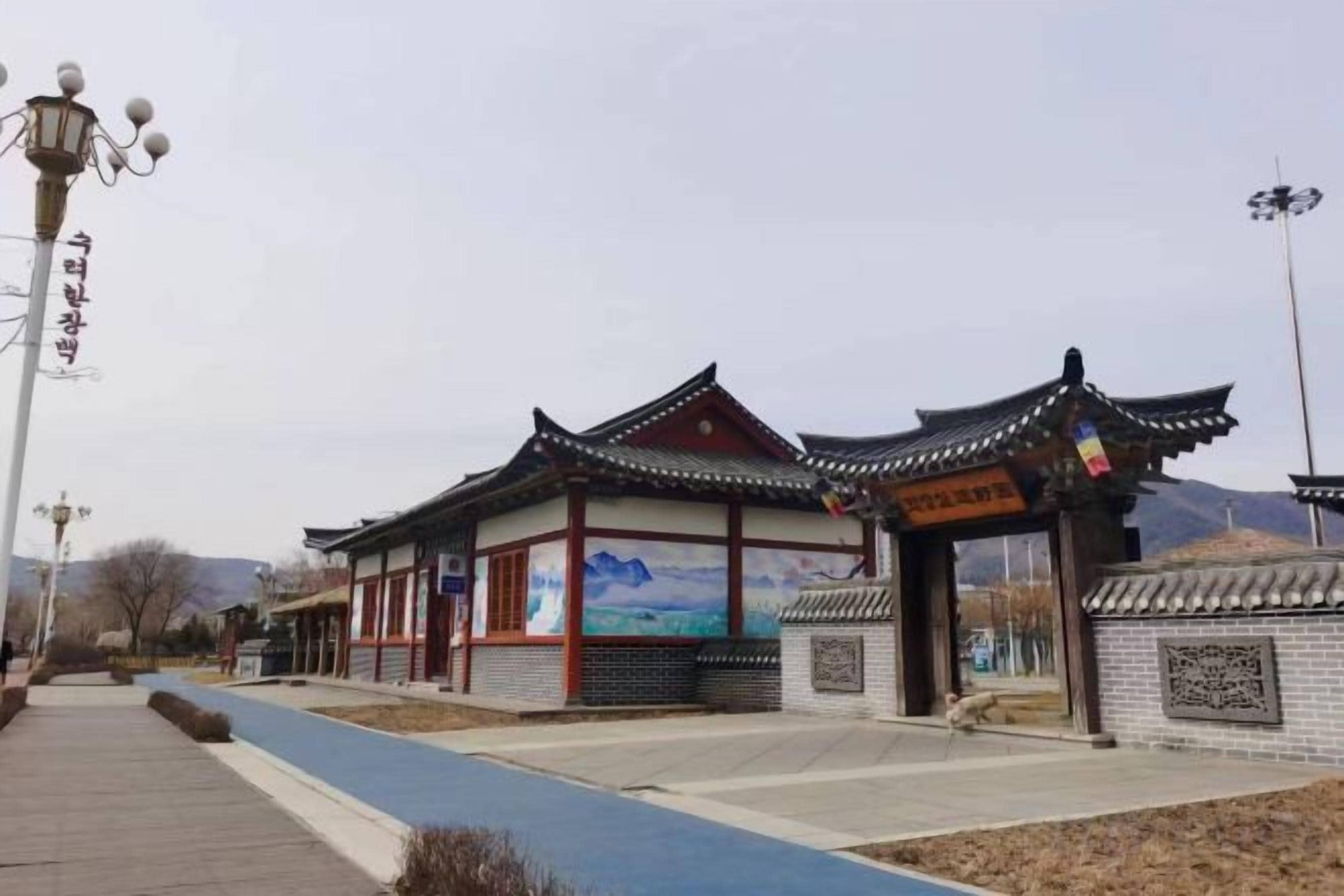 A traditional building with a tiled roof and a painted mural.