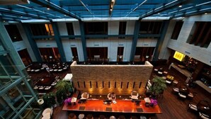 A spacious lobby with a long conference table, multiple seating areas, and a high ceiling with skylights. - Nanchang Qinyuan Villa (Nanchang)