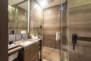 A modern bathroom with a glass-enclosed shower, a sink with a mirror, and a telephone mounted on the wall. - Nanchang Qinyuan Villa (Nanchang)