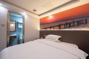 A hotel room with a bed, a nightstand, a bathroom with a glass door, and a sunset mural on the wall. - Shenzhen Haoyoulai Hotel (Dongmen Pedestrian Street Hubei Subway Station) (Shenzhen)