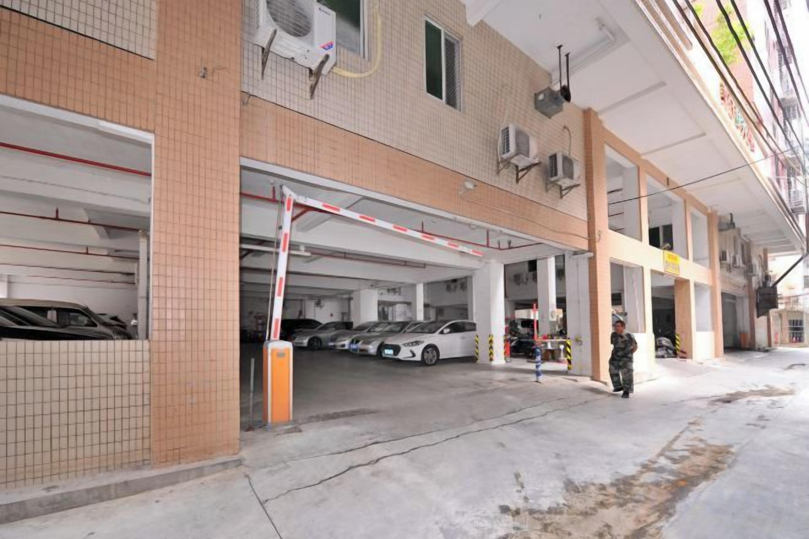 A parking garage with multiple levels and a gated entrance.