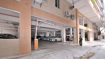 A parking garage with multiple levels and a gated entrance.