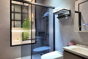 A modern bathroom with a glass-enclosed shower, a white sink, and a towel rack. - Meiting Garden Apartment (Shantou)