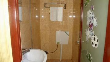A bathroom with a bathtub, a toilet, and a shower.