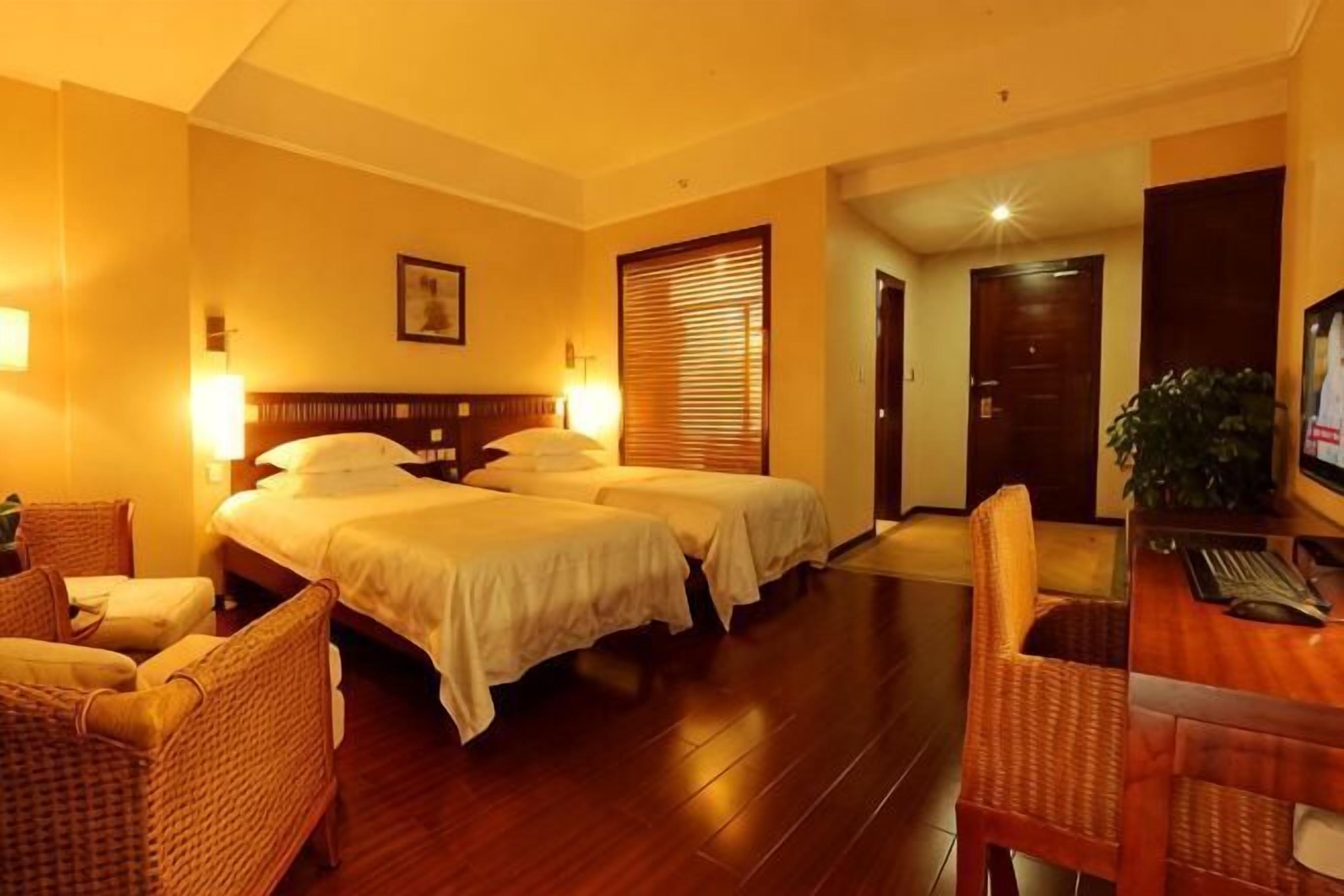 Una habitación de hotel con dos camas, un escritorio y una silla.