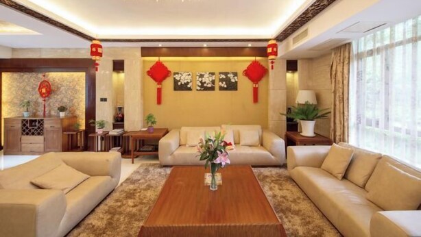 A modern living room with a sofa set, a coffee table, and decorative lanterns. - Landu Business Hotel (Tengchong)