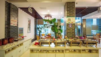 A restaurant with a brick wall, a wooden ceiling, and a buffet setup.