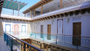 A multi-level courtyard with ornate railings and traditional architectural details.