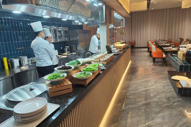 A buffet setup with various food items and a long counter.