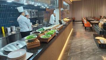 A buffet setup with various food items and a long counter.