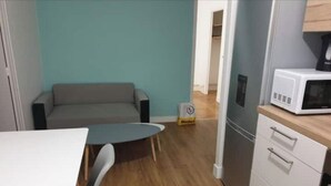 A compact kitchenette with a microwave, a small refrigerator, and a wooden countertop. - 3 rooms Grenoble - Saint Martin d'heres (Saint-Martin-d'Hères)