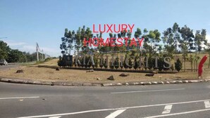 A sign for a property named "Luxury Homestay" with a view of a road and trees in the background. - OYO Homes 90567 Barakah Homestay (Tawau)