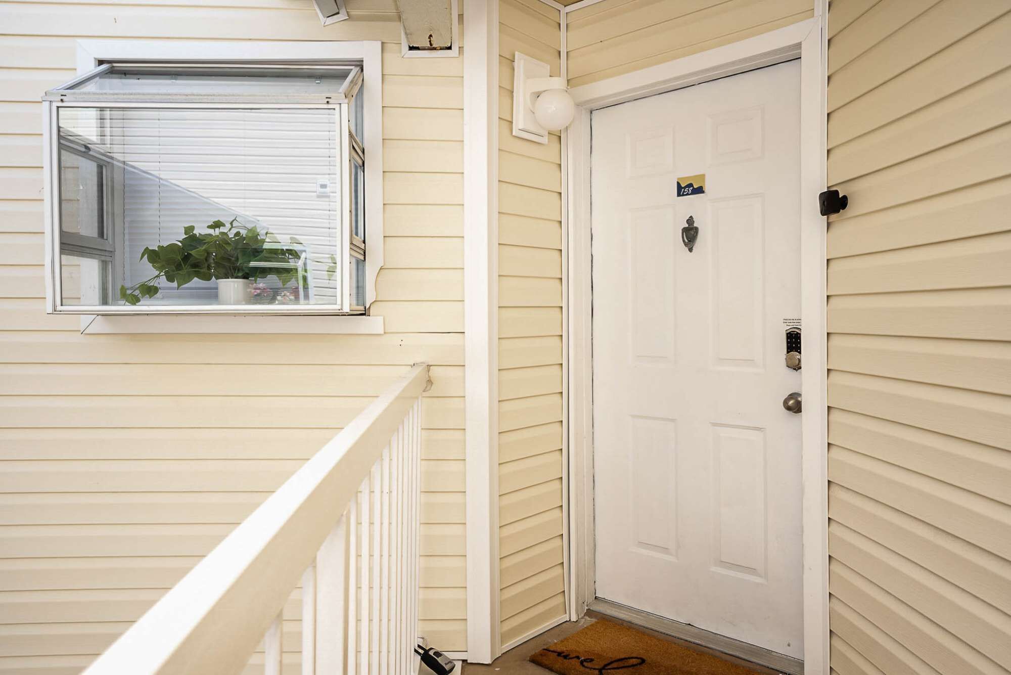 A white door with a lock and a small sign above it.