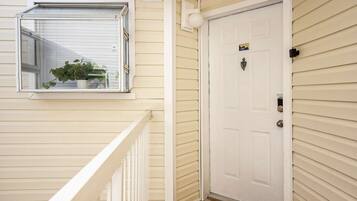 A white door with a lock and a small sign above it.