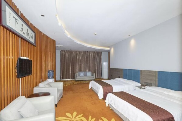 A hotel room with two beds, a sofa, a TV, and a large window with curtains. - Yiyuan Hotel (Shenzhen)
