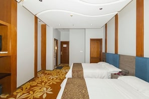 A hotel room with two beds, a wooden wardrobe, a television, and a patterned carpet. - Yiyuan Hotel (Shenzhen)