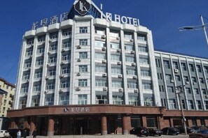 A multi-story hotel building with a prominent 'HOTEL' sign at the top.