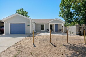 A residential building with a garage, a covered patio, and a fenced yard. - Ocean Oasis by Avantstay | Block to Beach | West PCB, Pet-Friendly (Panama City Beach)