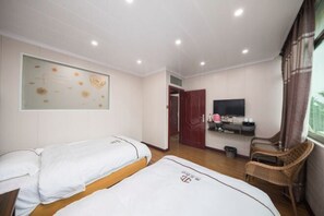 A hotel room with two beds, a television, a wall-mounted artwork, and a wicker chair. - Jiguang Hotel (Chongqing)