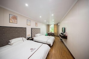 A hotel room with two beds, a TV, a desk, and a chair. - Jiguang Hotel (Chongqing)