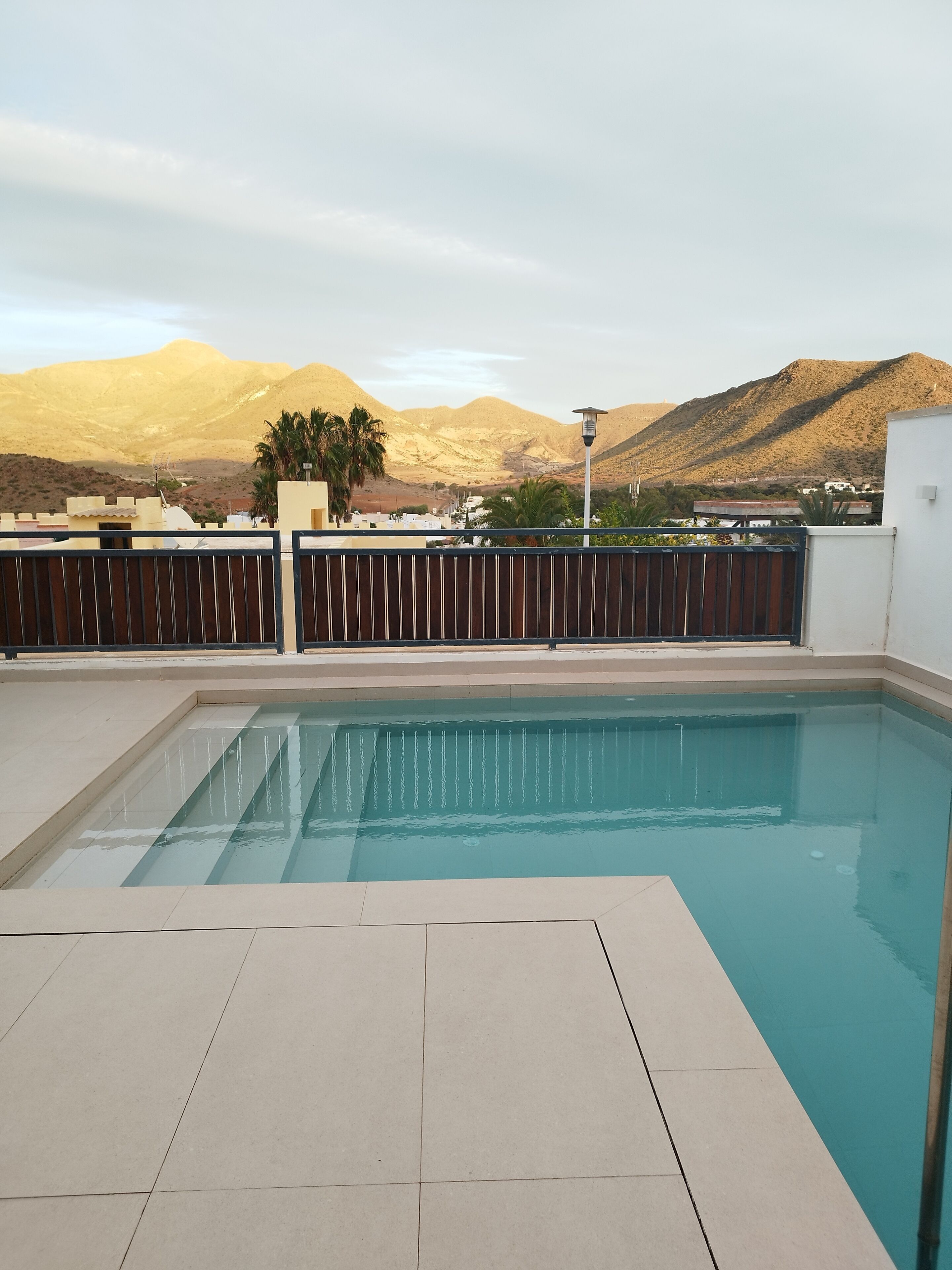 A swimming pool with a view of mountains in the background.