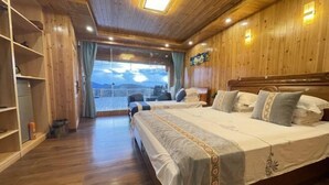 A wooden-paneled room with a large bed, a view through a window, and a shelf with items. - Mulihong Yuanwei Inn (Xiuning)