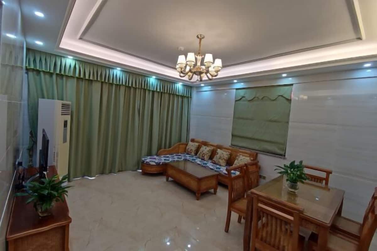 A living room with a sofa, coffee table, and dining table.