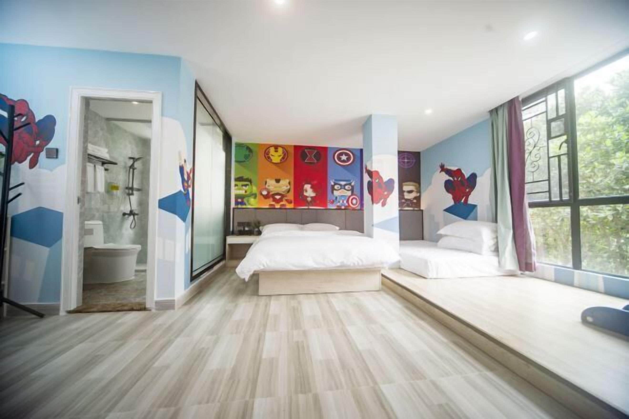 A bedroom with a bed, a window, and a bathroom visible through an open door.